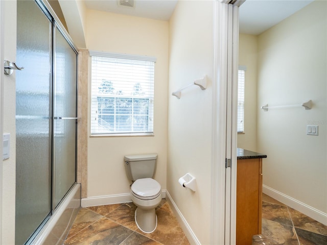 full bathroom with vanity, enclosed tub / shower combo, and toilet