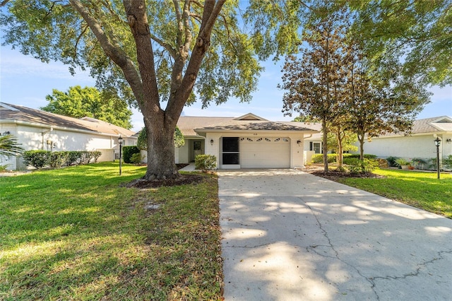 ranch-style house featuring a garage and a front lawn