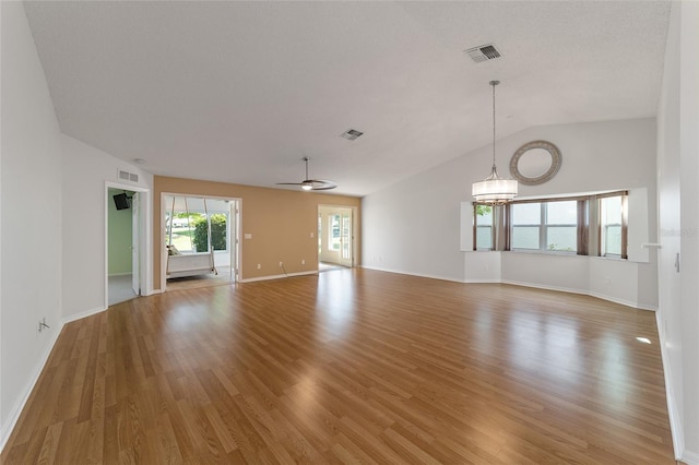 unfurnished living room featuring lofted ceiling and hardwood / wood-style flooring