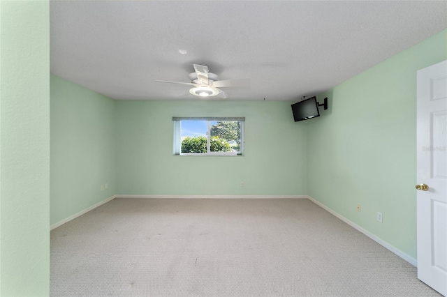 empty room featuring carpet and ceiling fan