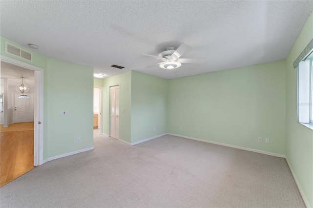 spare room with ceiling fan, hardwood / wood-style flooring, and a textured ceiling