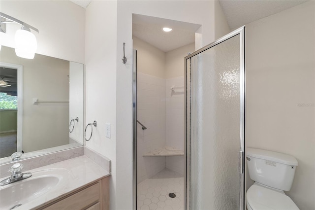 bathroom featuring a shower with shower door, toilet, oversized vanity, and a textured ceiling