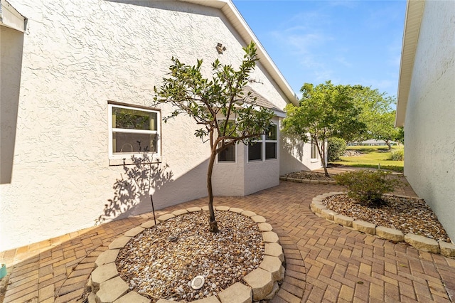 view of home's exterior with a fire pit and a patio