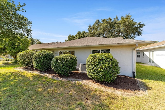 view of property exterior with a lawn