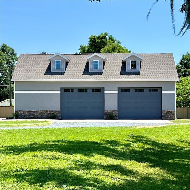 view of front of house with a front lawn and a garage