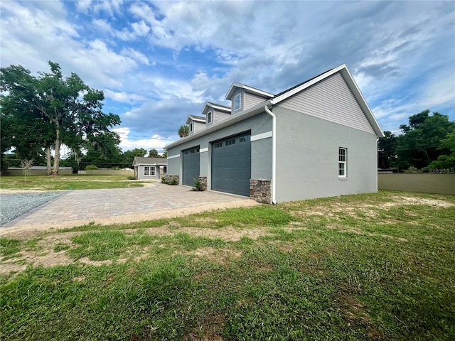 view of side of property with a yard and a garage