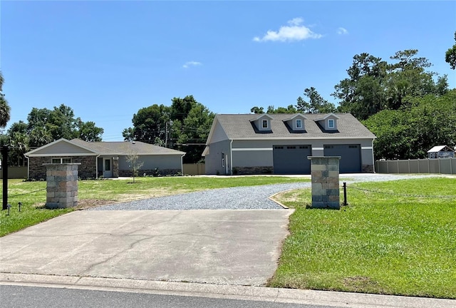 view of front of home with a garage and a front lawn