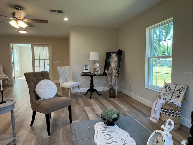 sitting room featuring ceiling fan and light hardwood / wood-style flooring