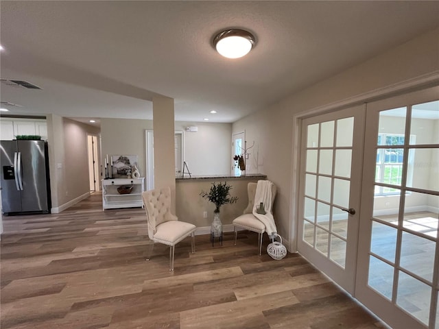 living area featuring french doors and hardwood / wood-style flooring