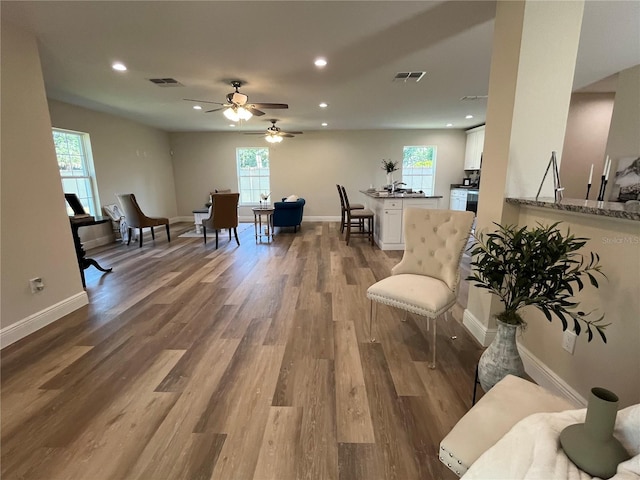 living room with ceiling fan, a healthy amount of sunlight, and hardwood / wood-style floors