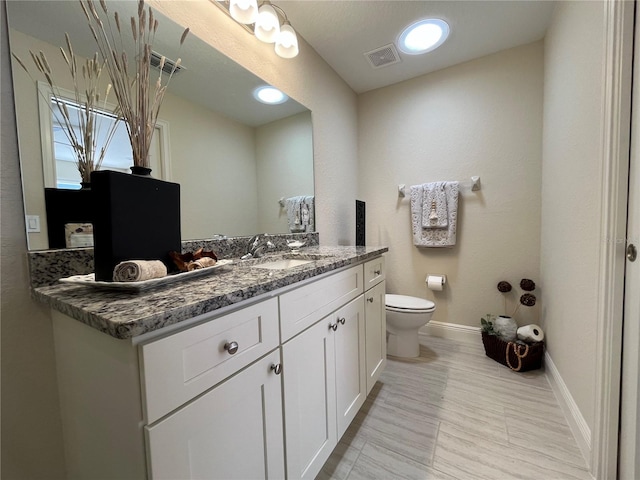 bathroom with vanity and toilet