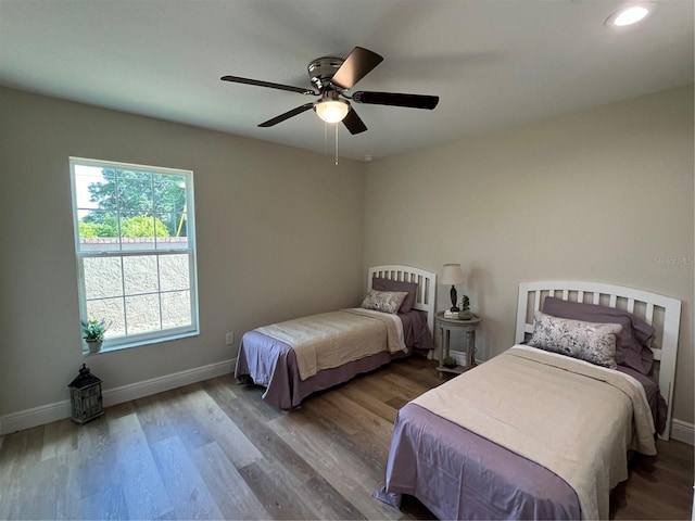 bedroom with wood-type flooring and ceiling fan