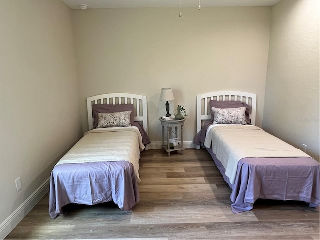 bedroom with dark hardwood / wood-style flooring