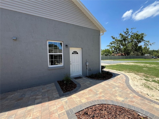 property entrance featuring a patio