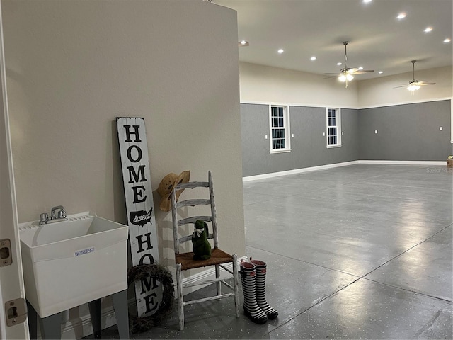 interior space with ceiling fan and sink