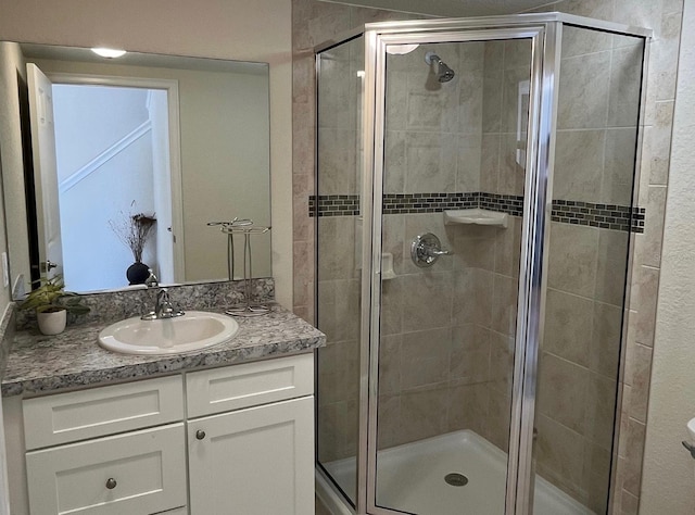 bathroom with walk in shower and vanity