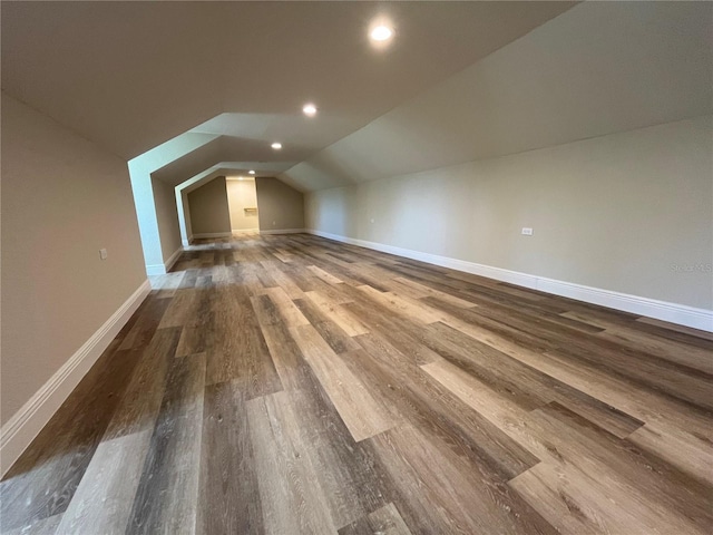 bonus room with lofted ceiling and hardwood / wood-style flooring