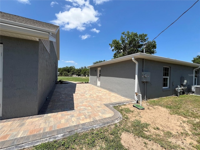 view of home's exterior featuring a patio and central AC unit