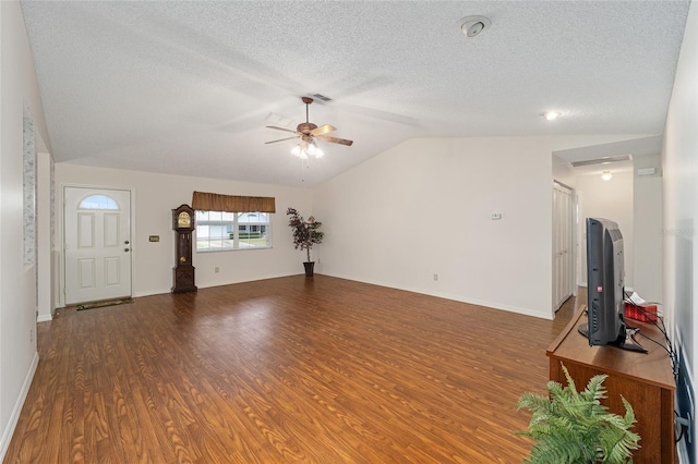 unfurnished living room with a textured ceiling, dark hardwood / wood-style flooring, vaulted ceiling, and ceiling fan