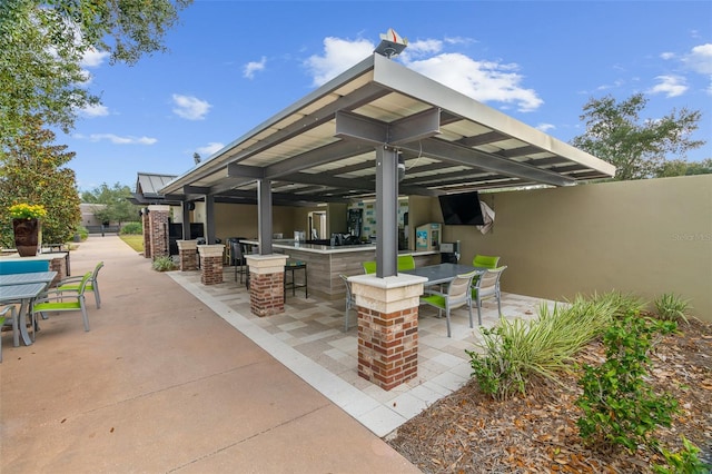 view of patio with an outdoor bar