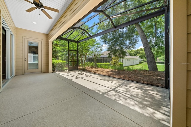 unfurnished sunroom featuring ceiling fan and lofted ceiling