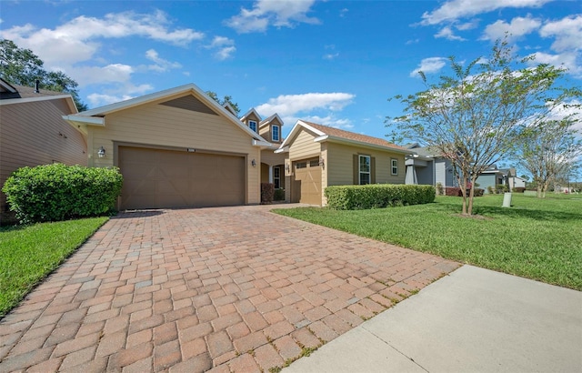 ranch-style home featuring a garage and a front yard