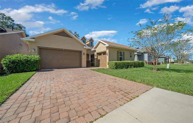 3396 NW 55th Ct, Ocala, FL 34482 - view of front of property featuring a garage, a front yard, and decorative driveway
