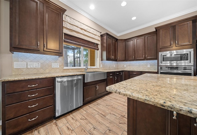 3396 NW 55th Ct, Ocala, FL 34482 - kitchen with stainless steel appliances, ornamental molding, light wood finished floors, dark brown cabinets, and backsplash
