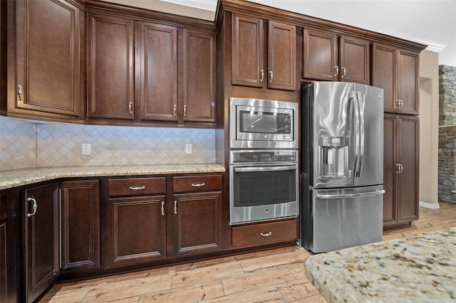 3396 NW 55th Ct, Ocala, FL 34482 - kitchen with appliances with stainless steel finishes, tasteful backsplash, and light wood-style flooring