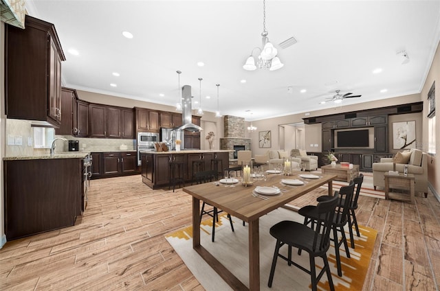 3396 NW 55th Ct, Ocala, FL 34482 - dining area with a chandelier, crown molding, recessed lighting, light wood finished floors, and a ceiling fan