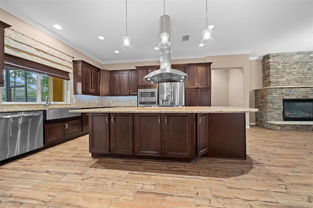 kitchen featuring decorative light fixtures, dark brown cabinets, light wood-type flooring, and appliances with stainless steel finishes