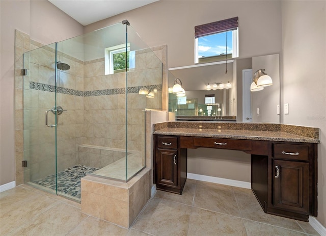 bathroom featuring tile patterned flooring, vanity, and walk in shower