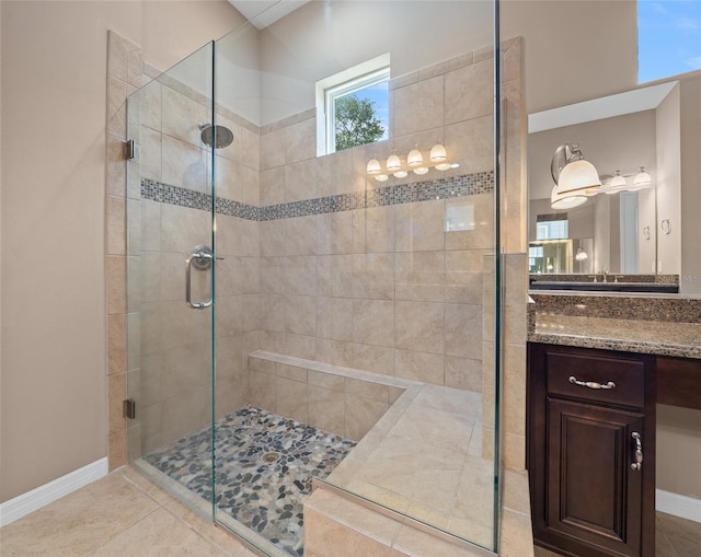 bathroom with tile patterned floors, a shower with door, and vanity