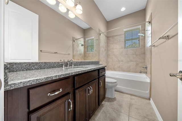 full bathroom with tile patterned flooring, vanity, tiled shower / bath combo, and toilet