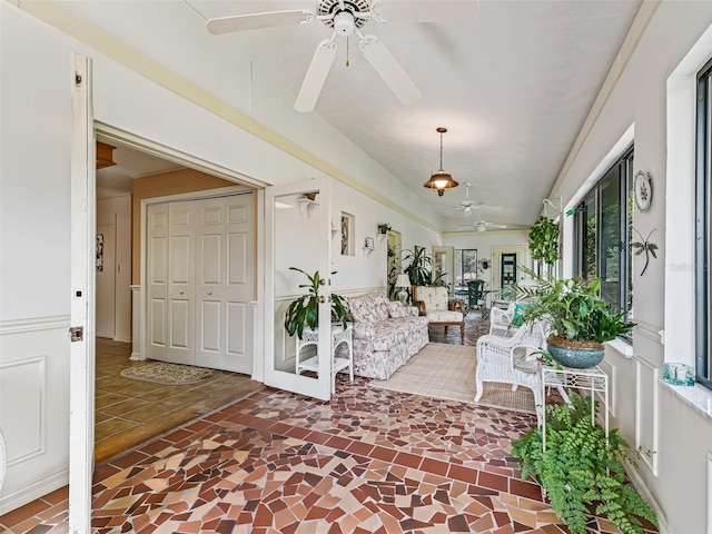 interior space with ceiling fan