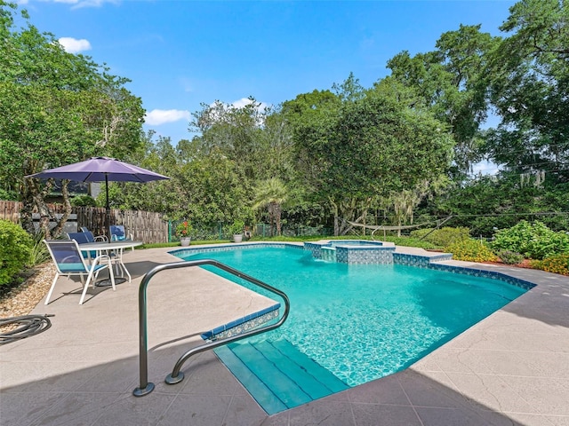 view of swimming pool featuring a patio and an in ground hot tub