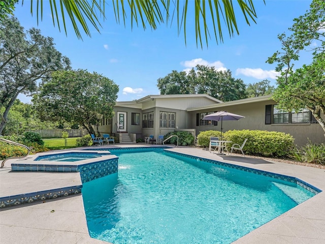 view of swimming pool with a patio and an in ground hot tub