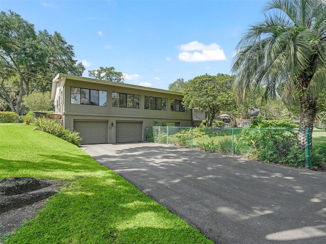 view of front of property with a garage and a front yard