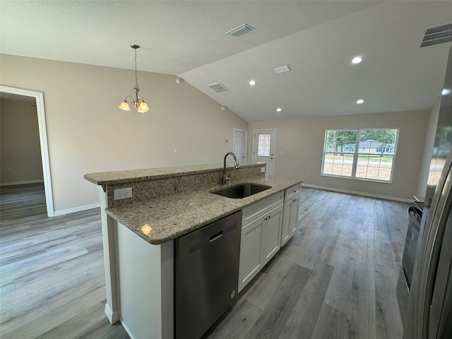 kitchen with dishwasher, white cabinets, sink, vaulted ceiling, and an island with sink