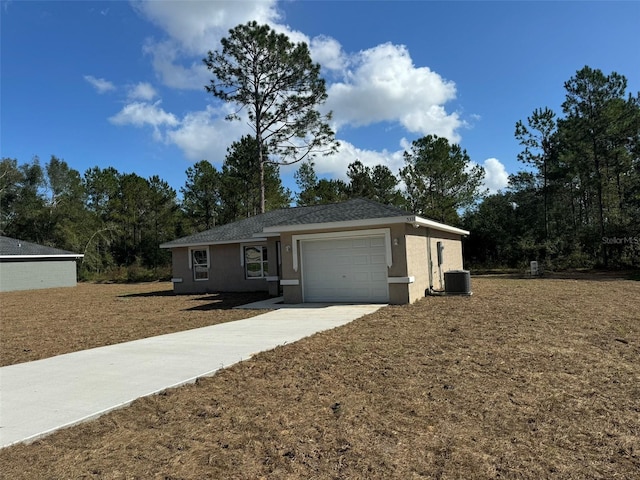 ranch-style house with cooling unit and a garage