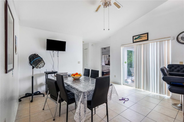 dining area with light tile flooring, ceiling fan, and lofted ceiling