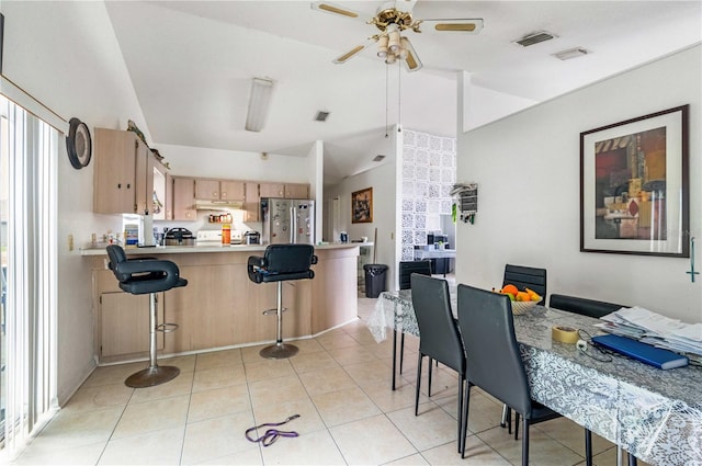 kitchen featuring ceiling fan, stainless steel fridge, light tile floors, and kitchen peninsula