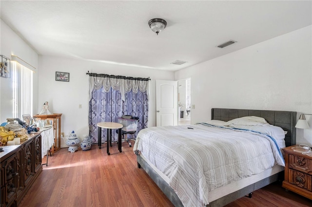 bedroom with hardwood / wood-style floors