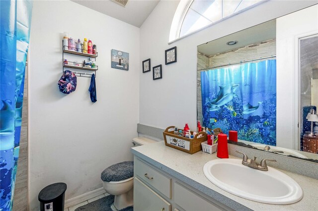 bathroom featuring large vanity and toilet