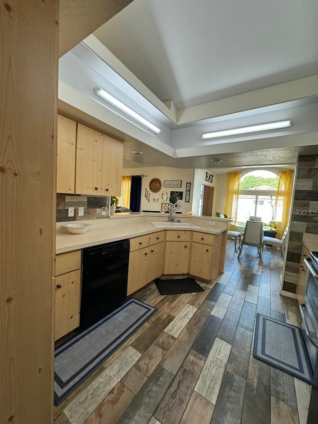 kitchen with black dishwasher, dark hardwood / wood-style flooring, light brown cabinets, and kitchen peninsula