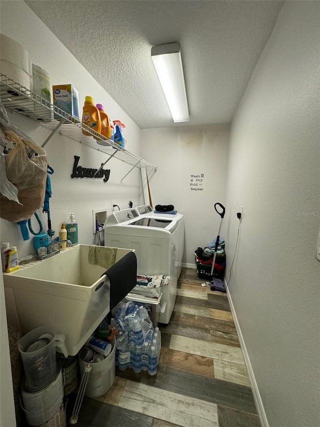 washroom featuring washer and clothes dryer, electric dryer hookup, hookup for a washing machine, hardwood / wood-style flooring, and a textured ceiling