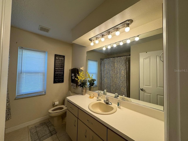 bathroom with vanity, toilet, and tile flooring