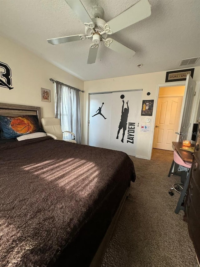 carpeted bedroom with a textured ceiling and ceiling fan