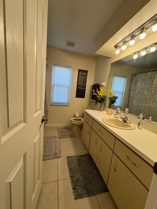 bathroom with vanity, toilet, and tile flooring