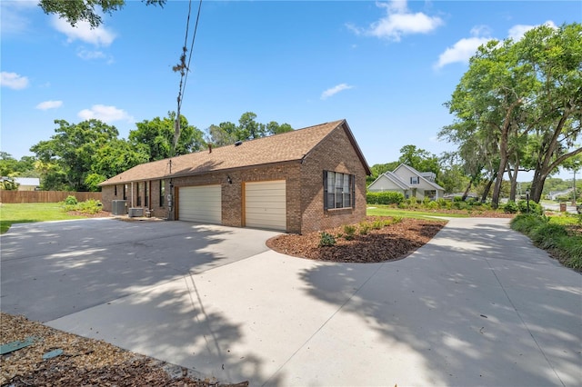 view of home's exterior with a garage and central AC unit